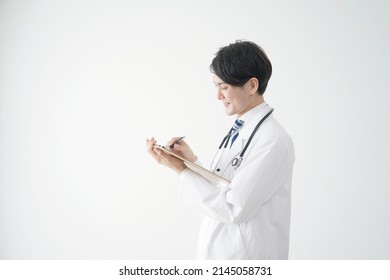 Asian Doctor Writing In White Background