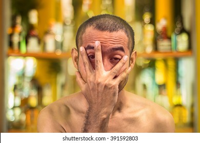 Asian Drunk Man With Naked Body Cover His Red Face By Hand Against Blur Alcohol Shelf Background,with Clipping Path