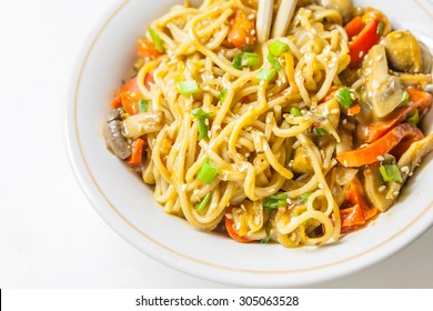 Asian Egg Noodles With Vegetables, Mushrooms, Green Onions And Sesame