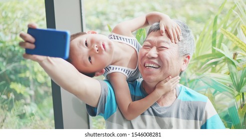 Asian Elder Grandfather Take Selfie With Kid Happily