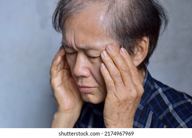 Asian Elder Man Massaging His Temple. Concept Of Eye Pain, Strain Or Cluster Headache.