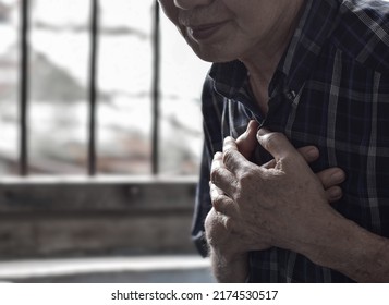 Asian Elder Man Suffering From Central Chest Pain. Chest Pain Can Be Caused By Heart Attack, Myocardial Infarct Or Ischemia, Myocarditis, Pneumonia, Stress, Etc.