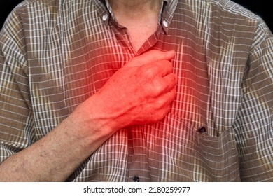 Asian Elder Man Suffering From Central Chest Pain. Chest Pain Can Be Caused By Heart Attack, Myocardial Infarct Or Ischemia, Myocarditis, Pneumonia, Oesophagitis, Stress, Etc,.