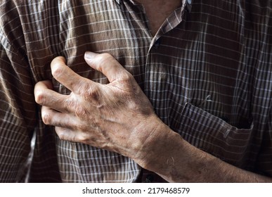 Asian elder man suffering from right sided chest pain. Chest pain can be caused by heart attack, myocardial infarct or ischemia, myocarditis, pneumonia, stress, etc. - Powered by Shutterstock