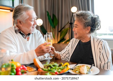 asian elder senior pension happiness cheerful,Beautiful senior couple toasting with glasses of wine sitting at wooden table.thanksgiving dinner christmas festive holiday,family celebrate concept - Powered by Shutterstock