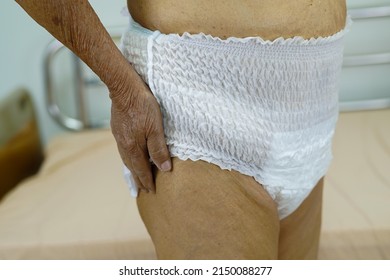 Asian Elder Senior Woman Patient Wearing Adult Incontinence Diaper Pad In Hospital.