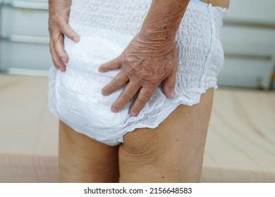 Asian Elder Senior Woman Patient Wearing Adult Incontinence Diaper Pad In Hospital.