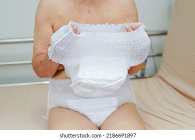 Asian Elder Senior Woman Patient Wearing Adult Incontinence Diaper Pad In Hospital.