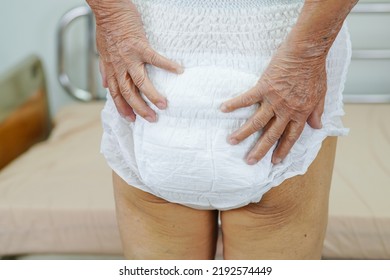 Asian Elder Senior Woman Patient Wearing Adult Incontinence Diaper Pad In Hospital.