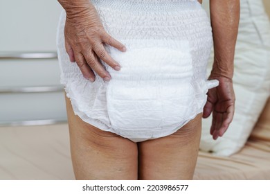 Asian Elder Senior Woman Patient Wearing Adult Incontinence Diaper Pad In Hospital.