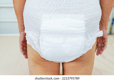 Asian Elder Senior Woman Patient Wearing Adult Incontinence Diaper Pad In Hospital.