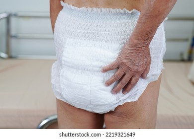 Asian Elder Senior Woman Patient Wearing Adult Incontinence Diaper Pad In Hospital.