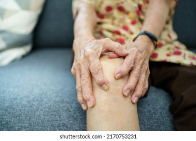 Asian Elder Woman Having A Critical Health Problem At Knee And Bone Joint, Woman Touching Or Holding At Knee. Elder Woman Getting Hurt And Injured At Her Leg.