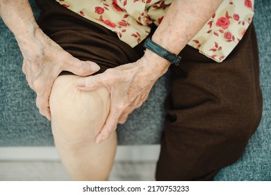 Asian Elder Woman Having A Critical Health Problem At Knee And Bone Joint, Woman Touching Or Holding At Knee. Elder Woman Getting Hurt And Injured At Her Leg.