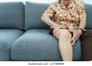 Asian Elder Woman Having A Critical Health Problem At Knee And Bone Joint, Woman Touching Or Holding At Knee. Elder Woman Getting Hurt And Injured At Her Leg.