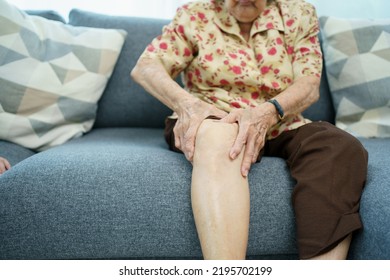 Asian Elder Woman Having A Critical Health Problem At Knee And Bone Joint, Woman Touching Or Holding At Knee. Elder Woman Getting Hurt And Injured At Her Leg.