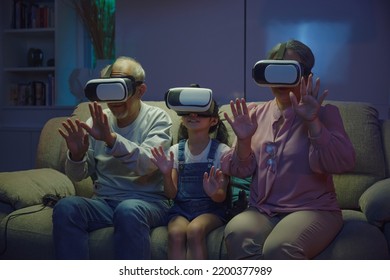 Asian elderly with child play VR video game, family entertainment, granddaughter and grandparents playing together exciting interesting video games using virtual reality headsets living room at home - Powered by Shutterstock