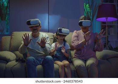 Asian elderly with child play VR video game, family entertainment, granddaughter and grandparents playing together exciting interesting video games using virtual reality headsets living room at home - Powered by Shutterstock