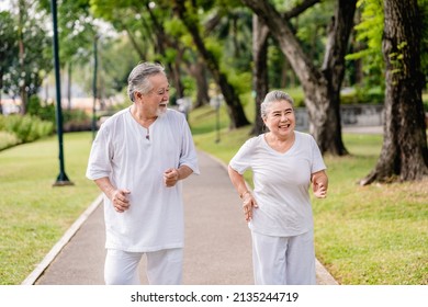 Asian Elderly Couple Jogging Or Exercise In The City Park, Retirement Leisure Activities, Life Insurance, And Health Care In Old Age Concept.