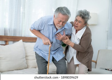 Asian Elderly Couple, Taking Care Of Health In Retirement, Elderly Asian Man With Chest Pain From A Heart Attack.