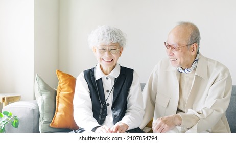 Asian Elderly Couple Talking In The Room.