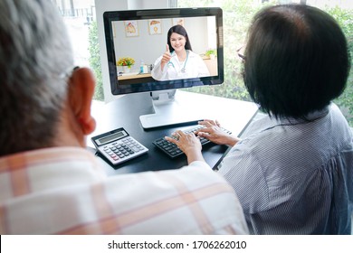 Asian elderly couples using computers Online video calling Talk to the doctor from home to inquire about health problems. Concept of social distance, hospital treatment