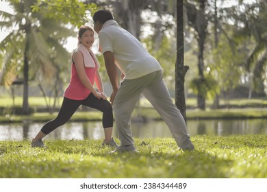 Asian Elderly Father and Daughter Enjoyed Exercising Together in The Natural Green Park. Health care and family bonding. - Powered by Shutterstock