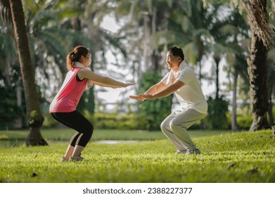 Asian Elderly Father and Daughter Enjoyed Exercising Together in The Natural Green Park. Health care and family bonding. - Powered by Shutterstock