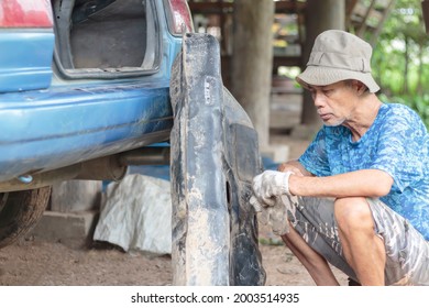 Asian Elderly Man Cleaning The Old Car Fuel Tank