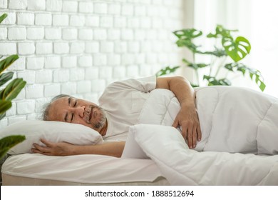 Asian Elderly man close eyes smile sleep and sweet dream on bed in bedroom in the morning feeling so relax and comfortable,Healthcare and Sleep Concept - Powered by Shutterstock