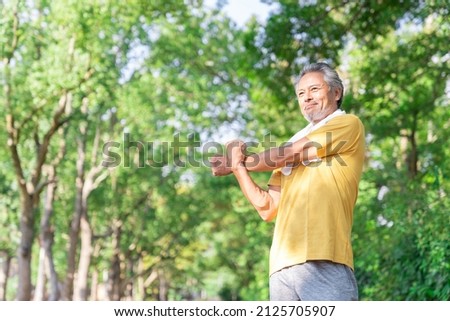 Asian elderly man exercising in the park