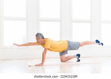 Asian elderly man exercising in the room - Powered by Shutterstock