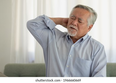 Asian Elderly Man With A Headache Sitting On A Bed In Morning