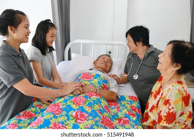 Asian Elderly Man Sleep On Bed In Hospital, Doctor And Family Visit And Discuss With Illness.