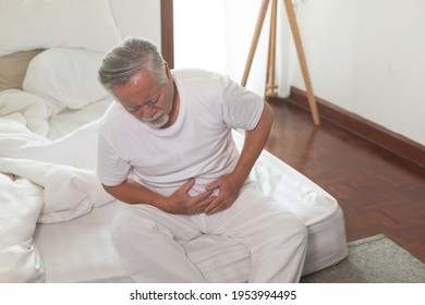 Asian Elderly man Stomachache in bedroom. - Powered by Shutterstock