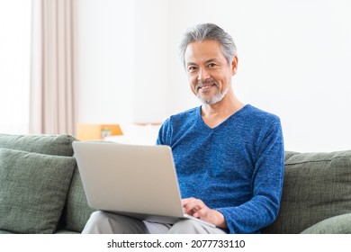 Asian elderly man using laptop