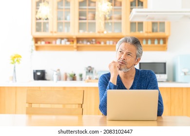 Asian elderly man using laptop, think, - Shutterstock ID 2083102447