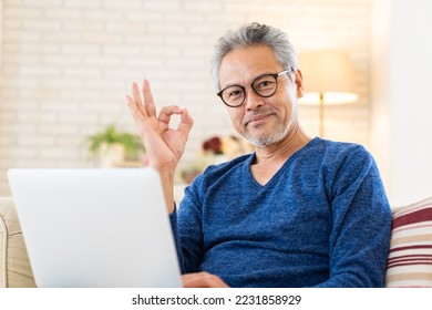 Asian elderly man using laptop - Shutterstock ID 2231858929