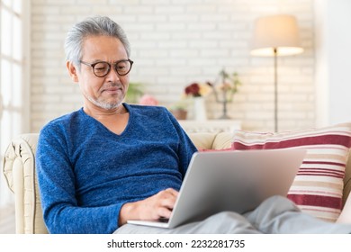 Asian elderly man using laptop - Powered by Shutterstock