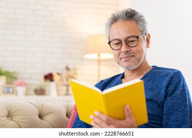 Asian elderly man who reads a book, - Powered by Shutterstock