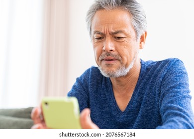 Asian elderly man who uses smart phone,think - Shutterstock ID 2076567184