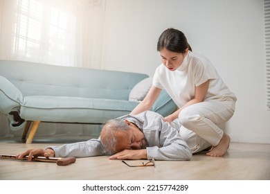 Asian Elderly Old Man With Walking Stick Fall On Ground And Granddaughter Camp To Help To Support At Home In Living Room, Young Woman Halping Her Grandfather After Falling Down On Floor, Dizziness