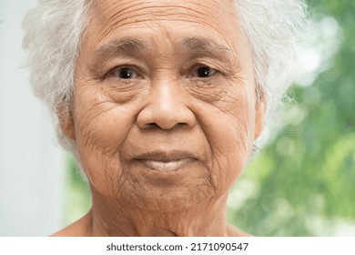 Asian Elderly Old Woman Face And Eye With Wrinkles, Portrait Closeup View.