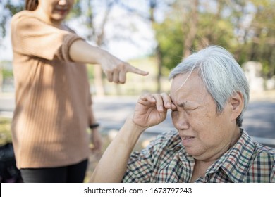 Asian Elderly People Crying While Young Caregiver Scolding,angry Annoyed Woman Getting Mad Pointing Finger To Senior Woman, Girl Yelling,shouting At Sad Old People,victim Of Violence And Abuse