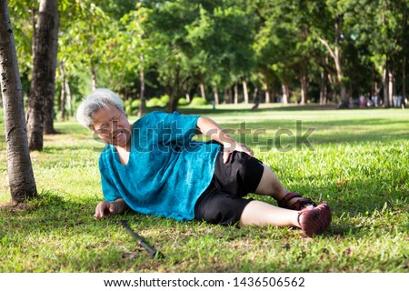 Asian elderly people with walker on floor after falling down in outdoor park,sick senior woman fell to the floor because of dizziness,faint or accident,suffering from illness,leg,knee pain, bone pain