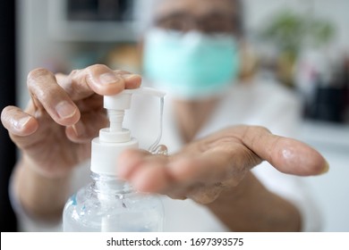 Asian elderly people wearing protective mask,using alcohol antiseptic gel,prevent infection,outbreak of Covid-19,senior woman washing hand with hand sanitizer to avoid contaminating with Coronavirus   - Shutterstock ID 1697393575