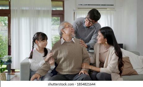 Asian Elderly Senior Male Grandpa Sitting At Sofa Couch At Home Living Room On Quarantine In Concept Healthcare, Chronic Health Issue Or Low Back Pain In Retired Older People With Family.