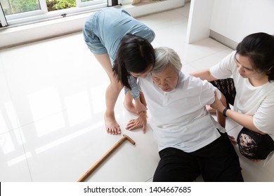 Asian Elderly With Walking Stick On Floor After Falling Down And Caring Young Woman Assistant,sick Senior Or Mother Fell To The Floor Because Of Dizziness And Having A Daughter,granddaughter To Help