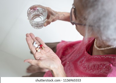 Asian Elderly Woman Are Taking And Eating Medicines And Vitamins For Help Sick And Healthy At Home,health Care Concept