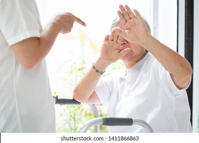Asian elderly woman were physically abused,attacking in house,angry man raised punishment fist,stop physical abuse senior people,caregiver,family stop violence and aggression concept